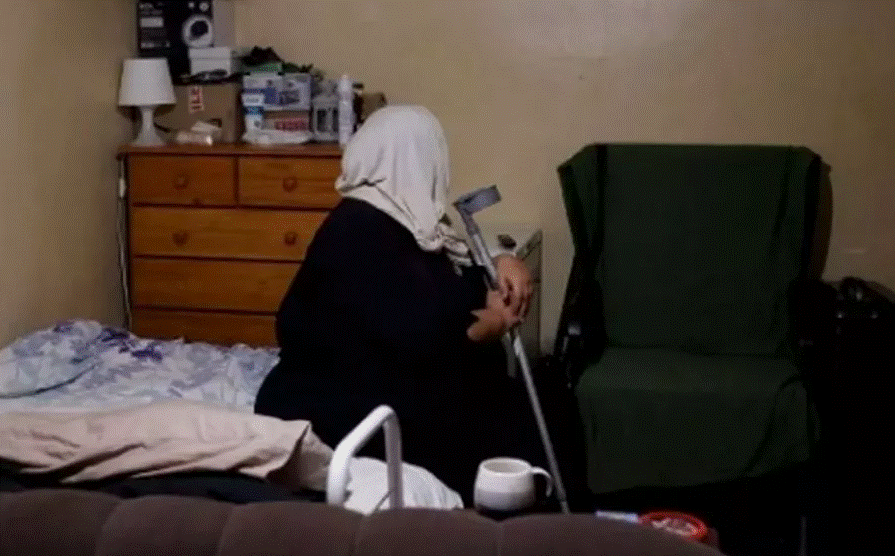a back view of the woman holding a crutch